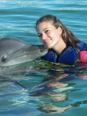 Mujer nadando con un delfin